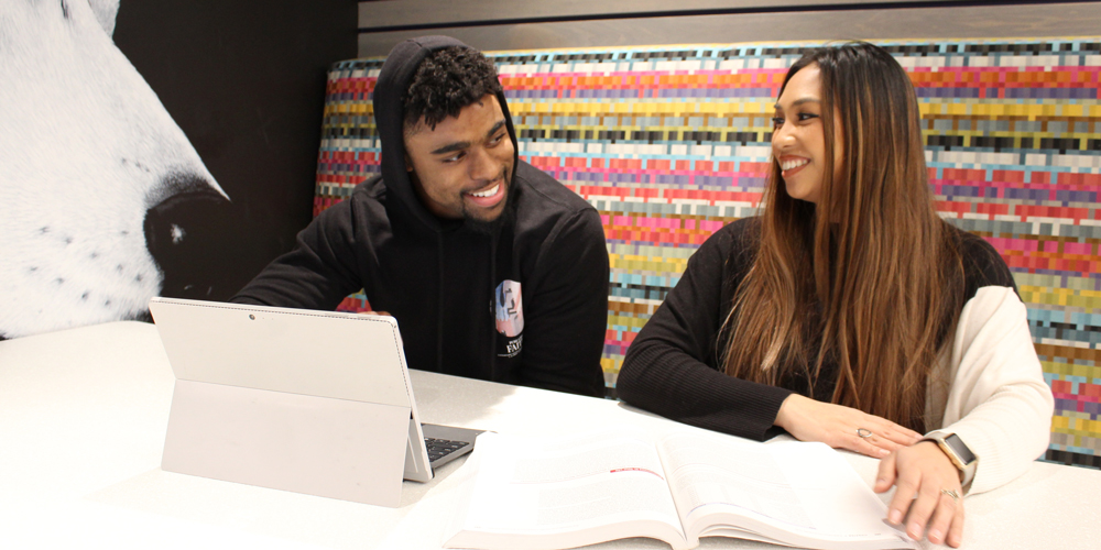 Salvon Ahmed and Liberty Bracken, Director of Football Academics, in Ackerley Academic Center