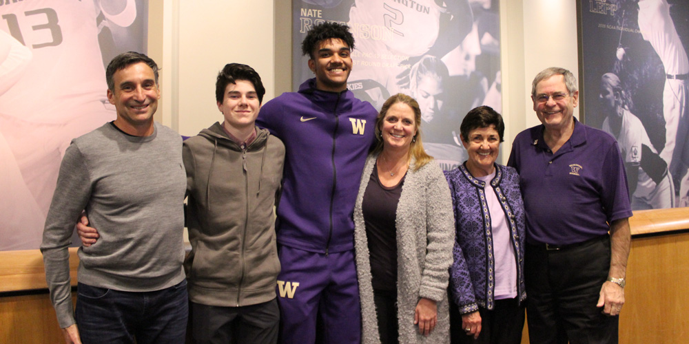 The Rossmeissl and Cummings family with scholarship recipient Jamal Bey