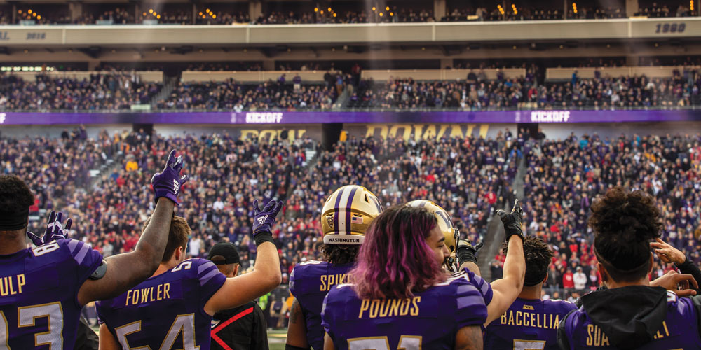 Football sideline doing hat chant