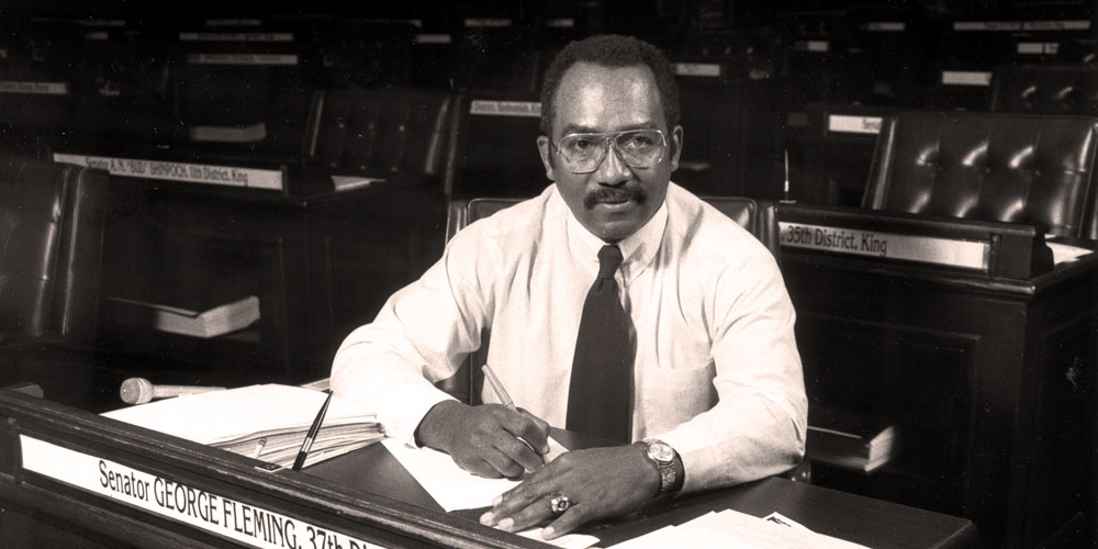 Senator George Fleming sits at desk