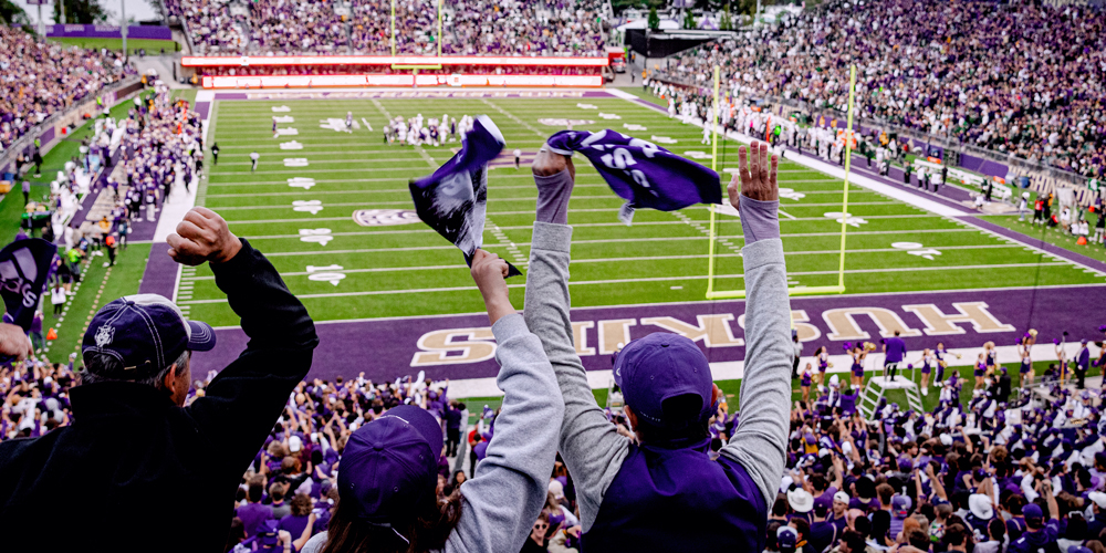 Football fans cheering with rally towels