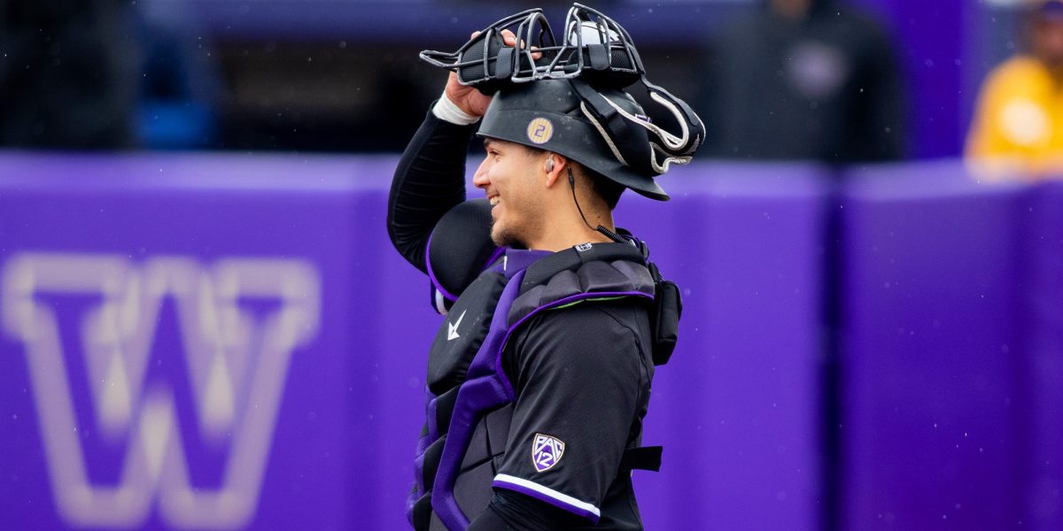 Baseball's Johnny Tincher smiling with catcher's mask lifted