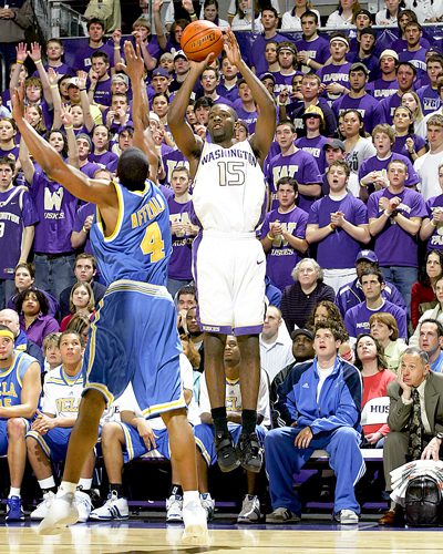 Bobby Ray Jones shoots a three over the outstretched arms of a UCLA player