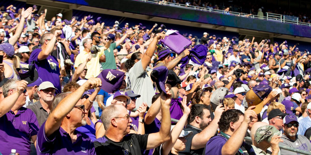 Fans at Husky Stadium doing the hat chant