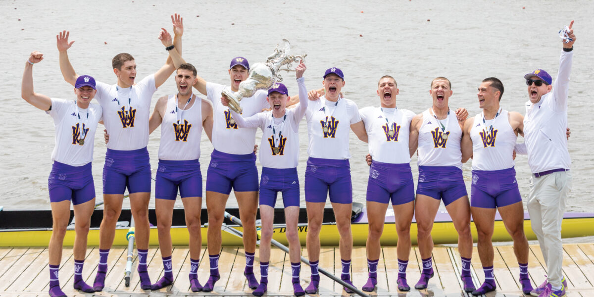 Men's Rowing cheering and holding IRA Championship trophy