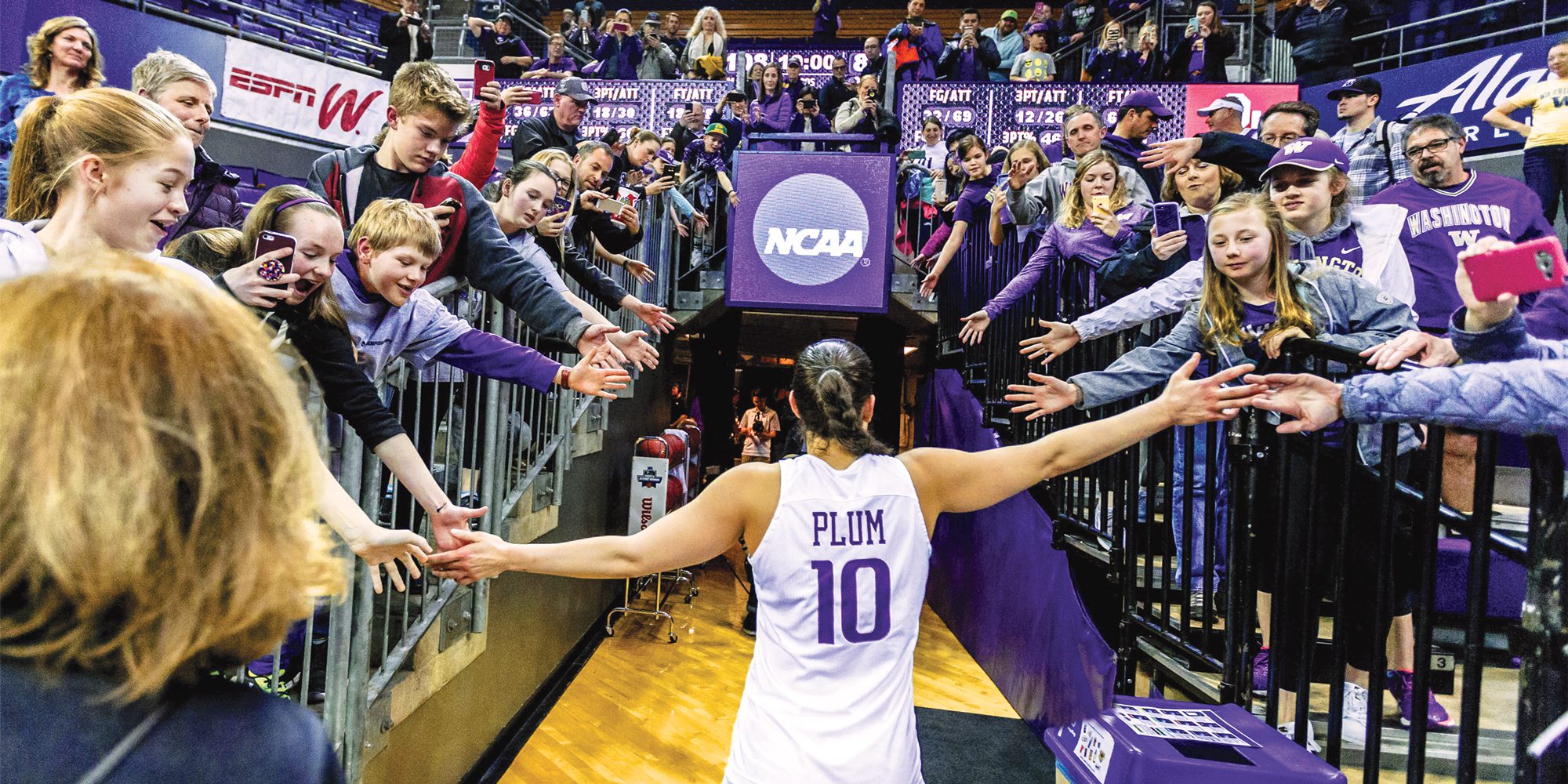 Kelsey Plum high-fives fans while exiting floor of Hec Ed