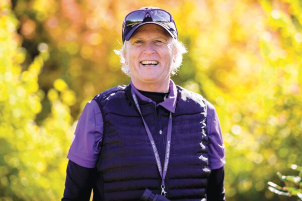 Women's Golf Head Coach Mary Lou Mulflur smiles in fall landscape