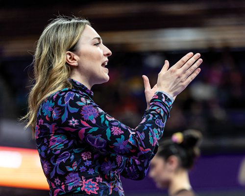 Head Gymnastics Coach Jessa Hansen Parker cheers on team