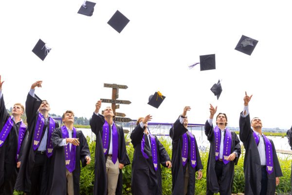 Men's rowers throw graduation caps in sky
