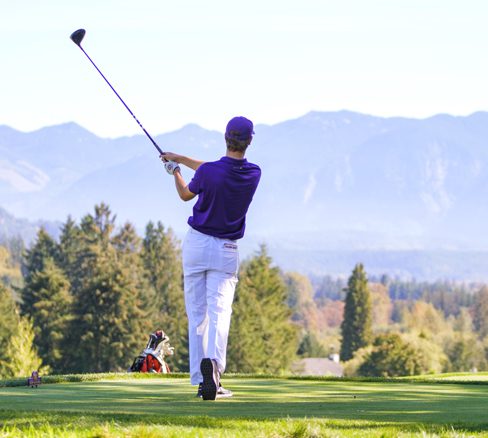 Men's golfer tees off