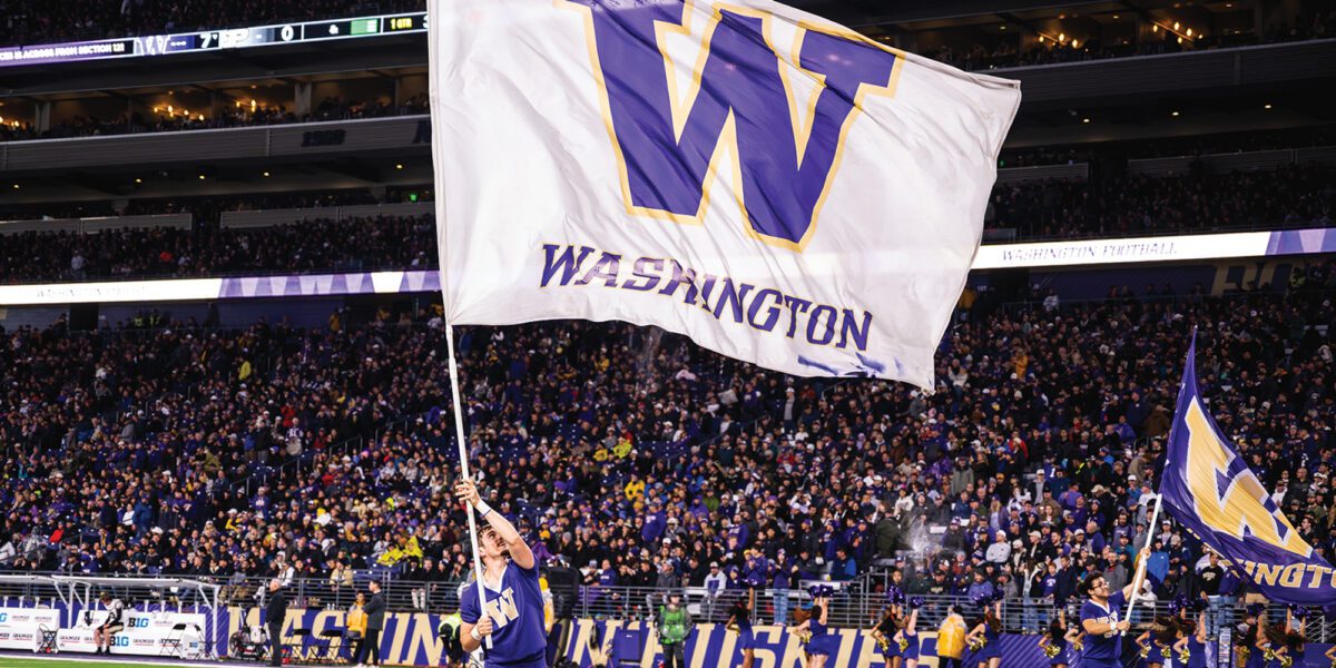 Cheerleaders waving Washington flags at Husky Stadium