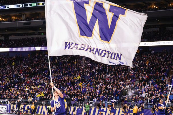 Cheerleaders waving Washington flags at Husky Stadium