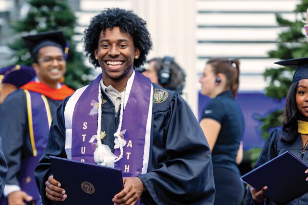 Track & Field's Prestin Artis collects diploma at 2025 UW Commencement
